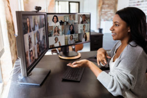 Woman teleconferences with colleagues