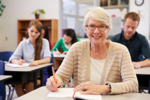Mature woman at desk in classroom