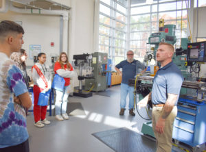 Justin Stanley, a QVCC manufacturing instructor, gives students an overview of the technology and machinery in the Advanced Manufacturing Technology Center.