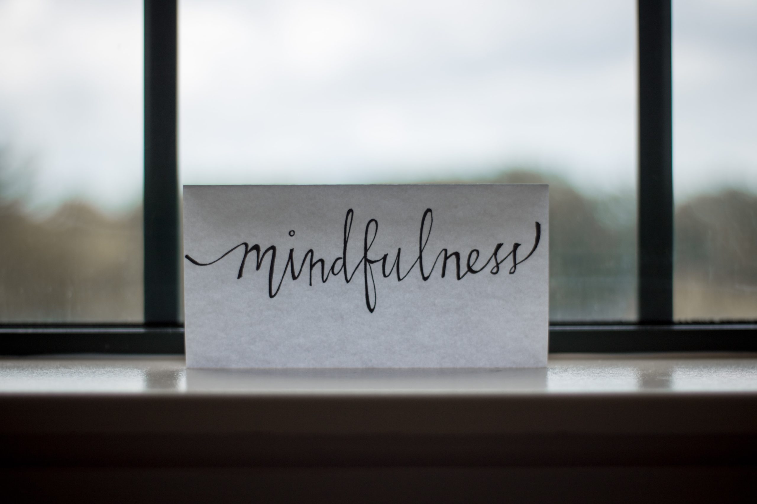 sign in front of window that said mindfulness