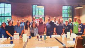 group stands behind table